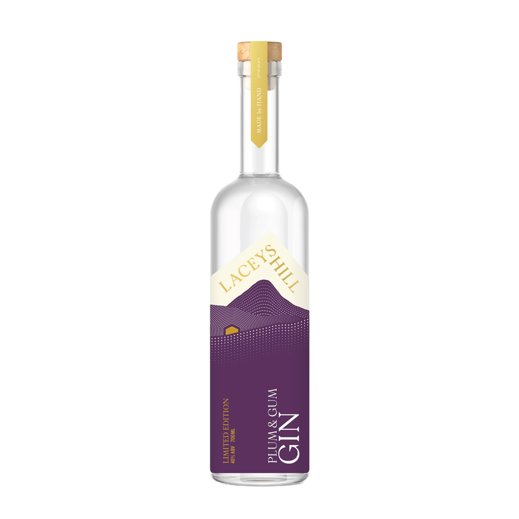 A bottle of Plum & Gum Gin with a purple label, clear glass, and a gold cap.